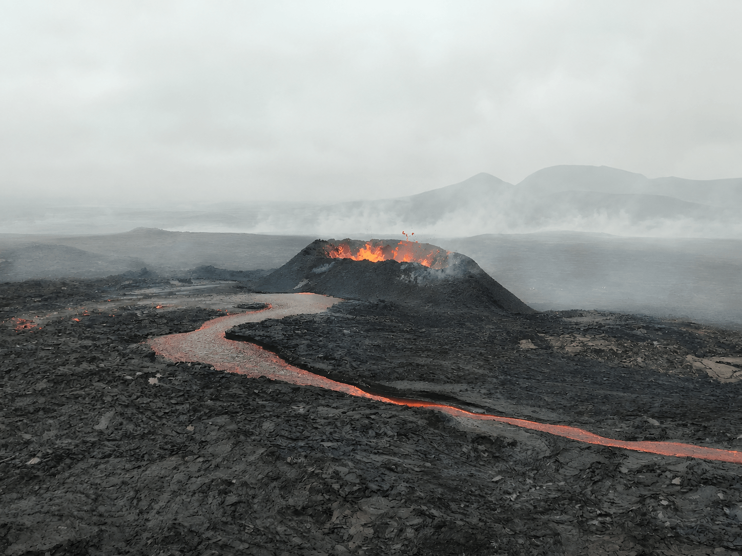Personal photograph of the 2024 eruption on the Reykjanes Peninsula, showing a glowing lava stream and crater.
